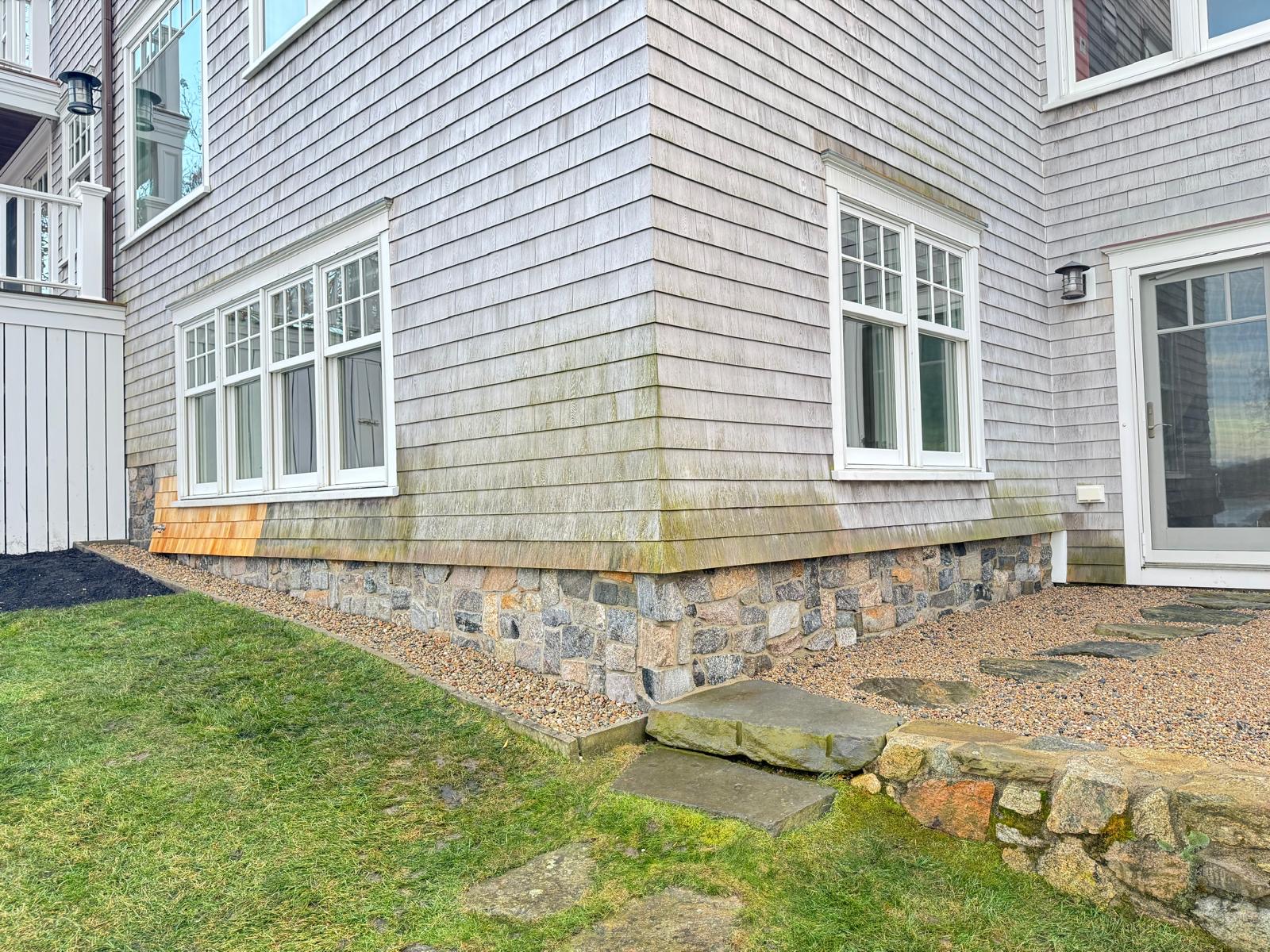 Home with stone veneer foundation and bluestone step by Armour Tech Masonry
